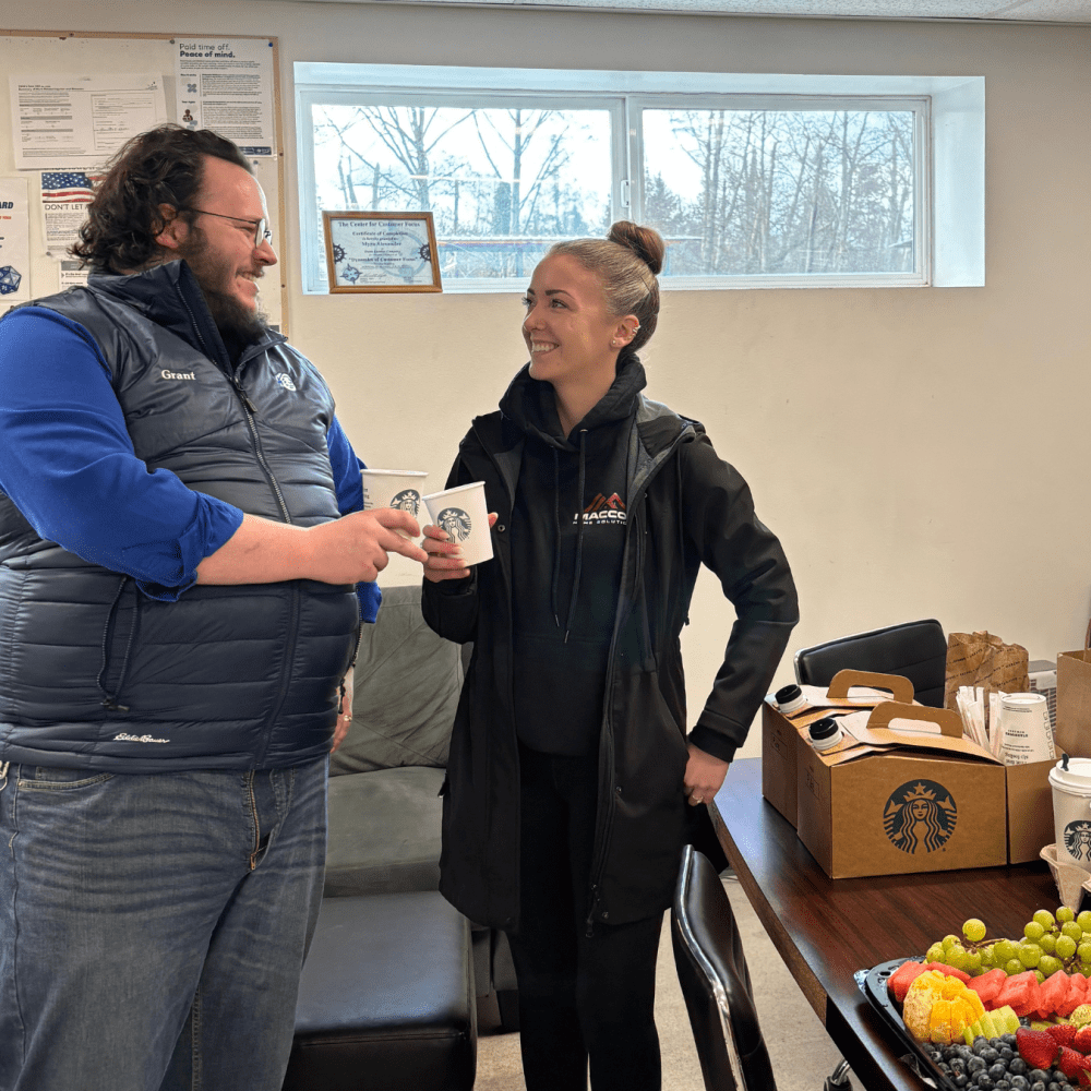 MacCoy Home Solution's Team Discussing while holding a Starbucks Coffee